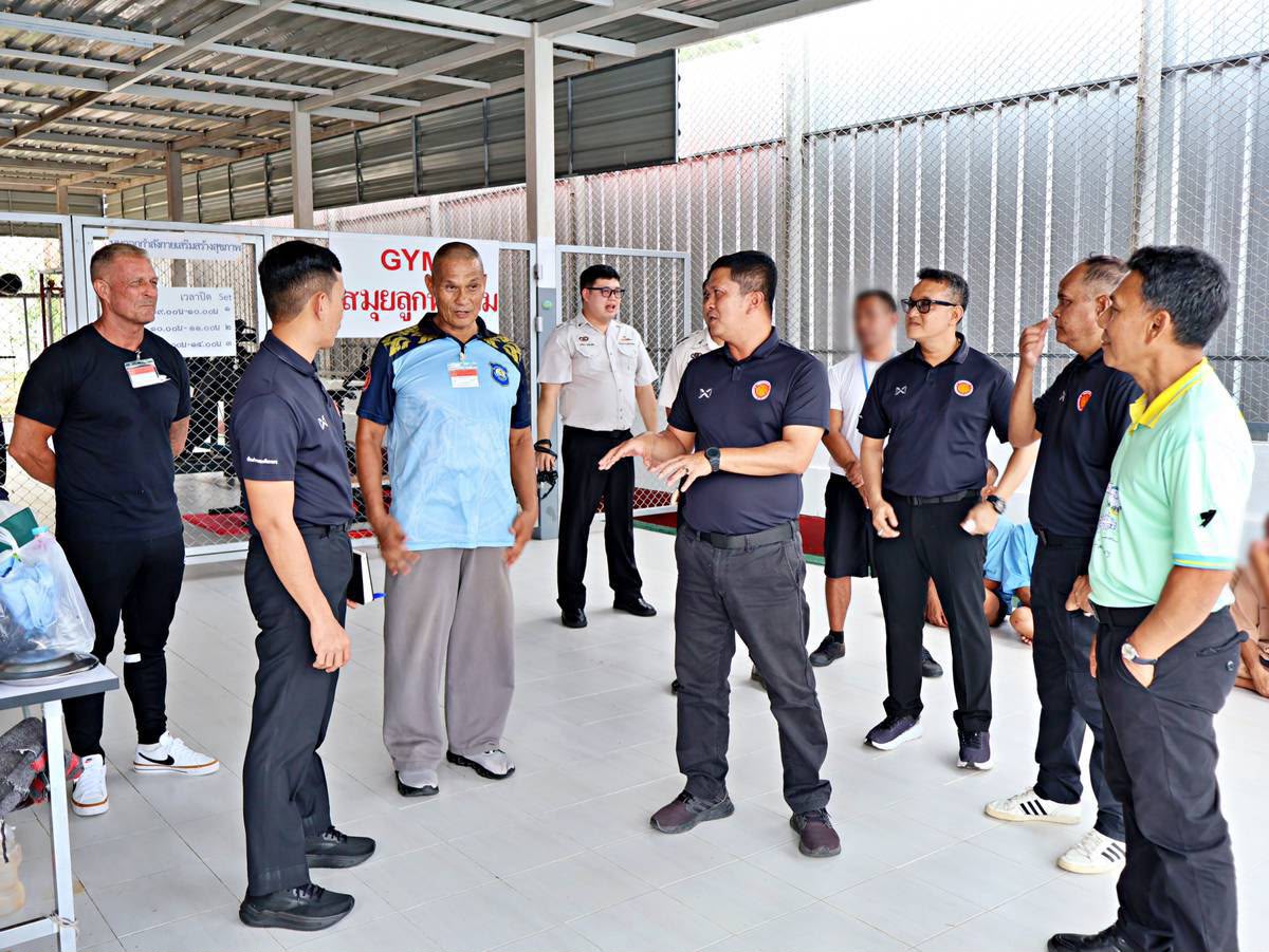 Coaches and prison officials touring the new gym facility at Koh Samui Prison